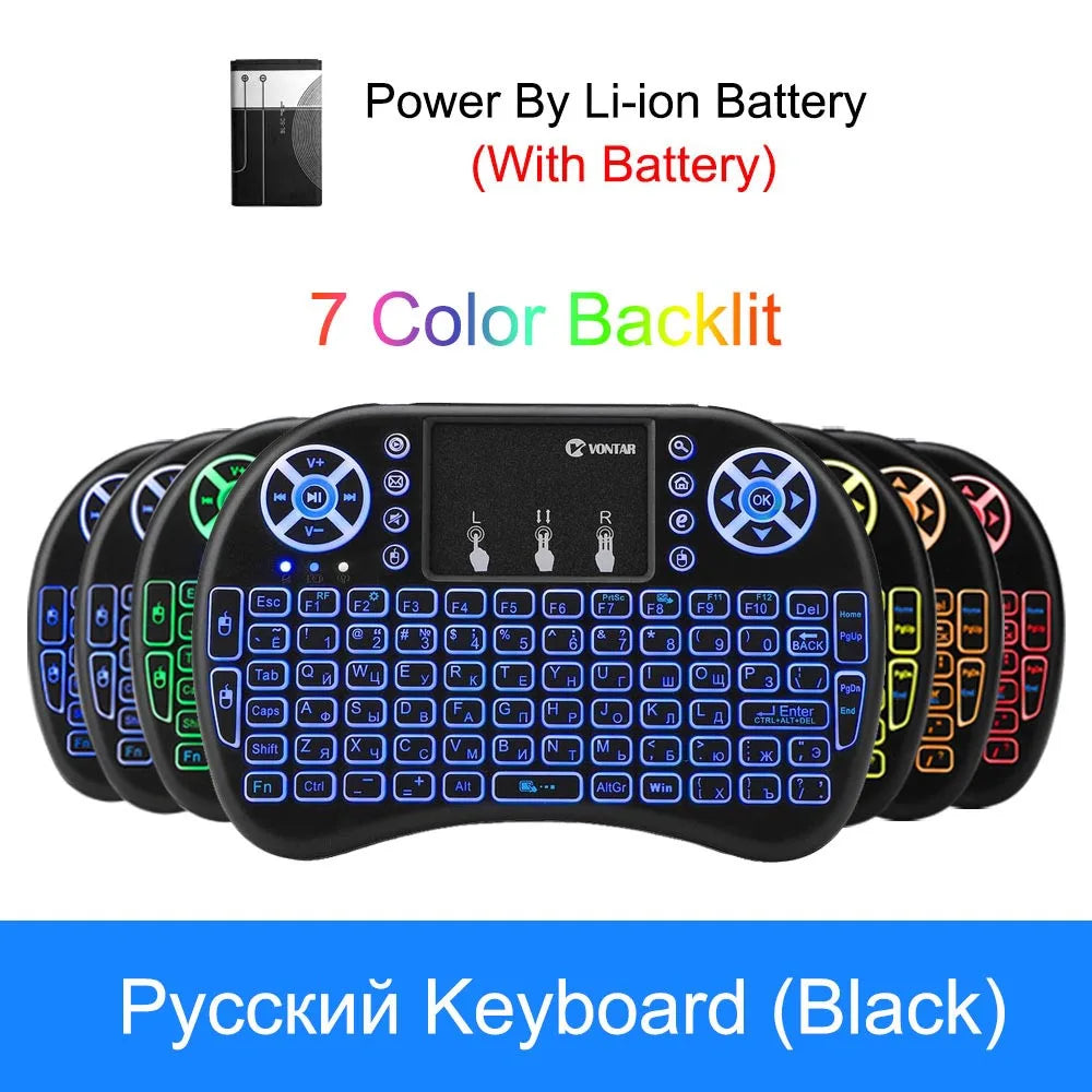 Black wireless mini keyboard with integrated touchpad and 7-colour backlit keys, powered by a rechargeable Li-ion battery.