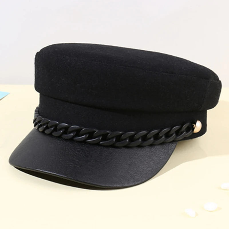 Black felt military-style cap featuring a decorative black chain across the front and a textured peak.