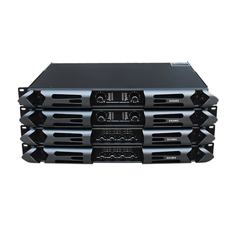 Stack of four professional 1000W 4-channel power amplifiers with black and grey rack-mount cases and volume dials.