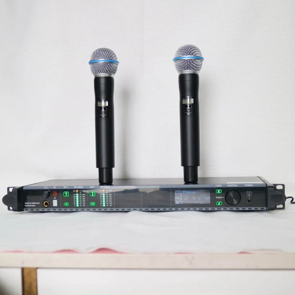 Two black wireless handheld microphones standing on a sleek, black receiver unit with digital displays and green lights.