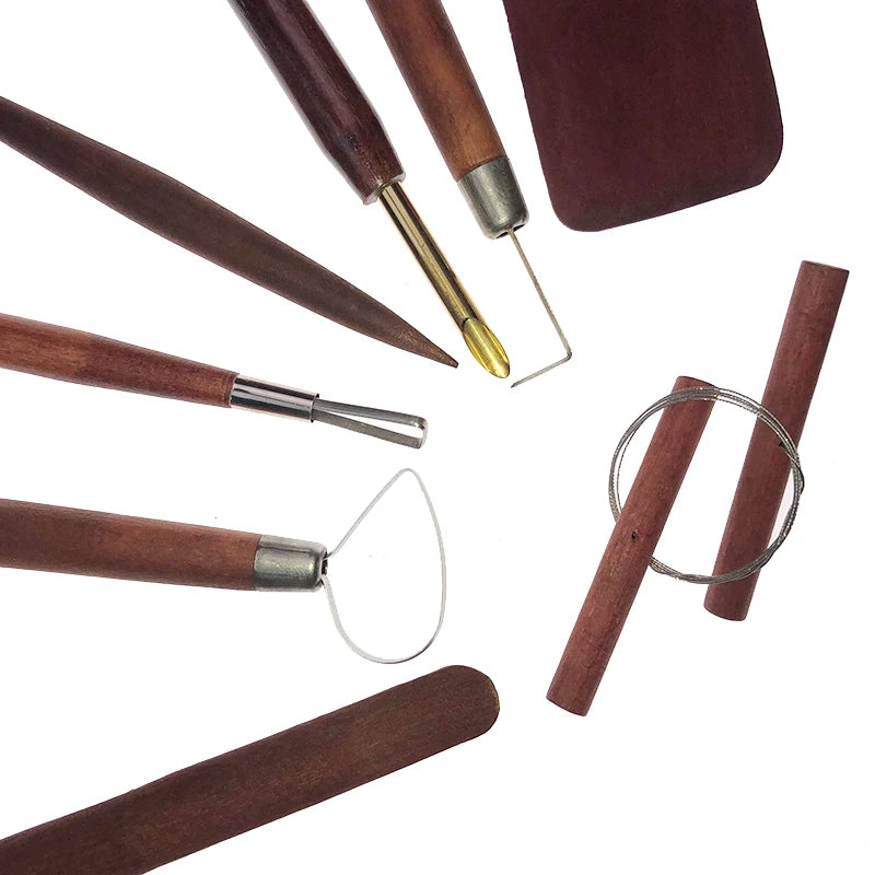Set of pottery sculpting tools with dark wood handles and various metal wire loops, tips, and smoothing blades.