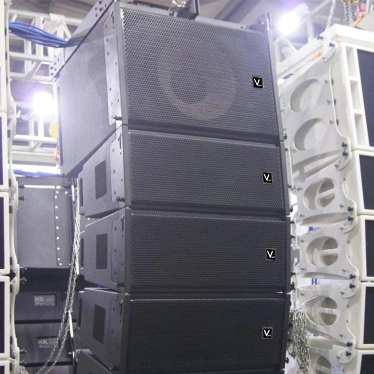 Stack of four professional black stage line-array speakers with mesh metal grilles, hanging from a truss system.