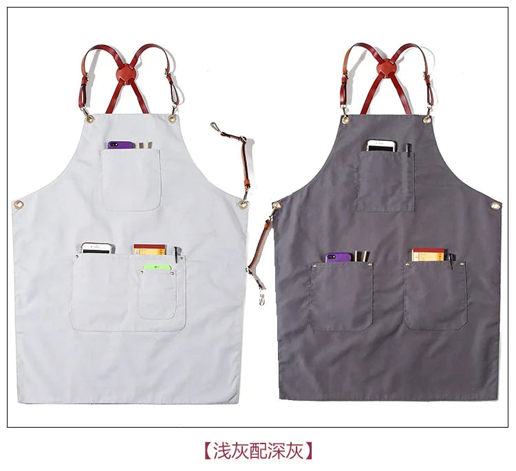 Two light and dark grey canvas work aprons with multiple front pockets and brown leather cross-back straps.
