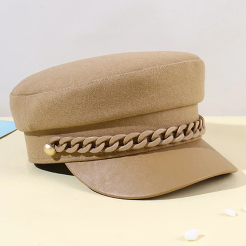 Camel-coloured felt baker boy cap featuring a decorative matching chain across the front and a smooth peak.