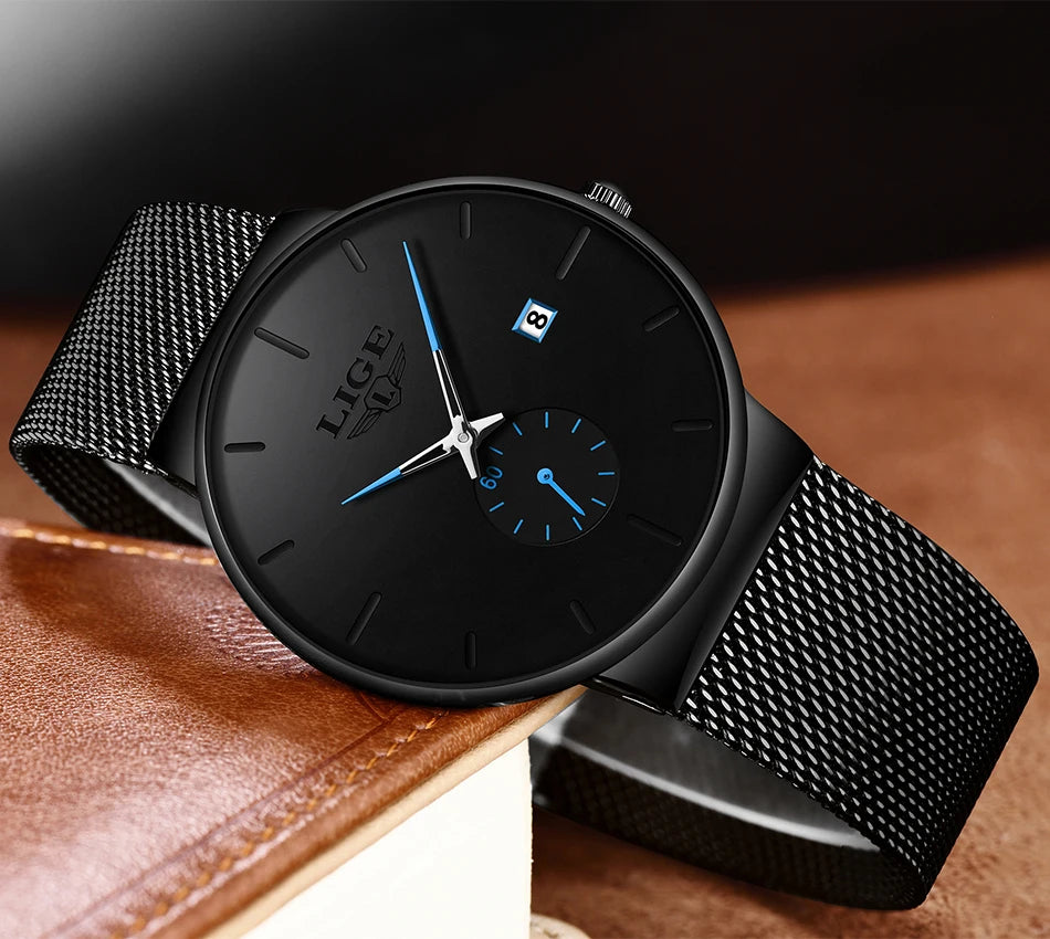 Elegant ultra-thin women's quartz watch in black with a stainless steel mesh strap, blue accents, and a date display.