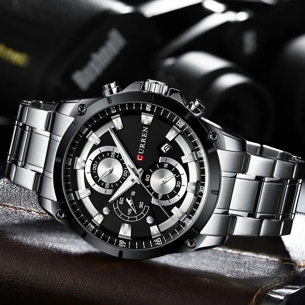 Men’s luxury silver stainless steel watch with a black dial, chronograph sub-dials, and a date display.