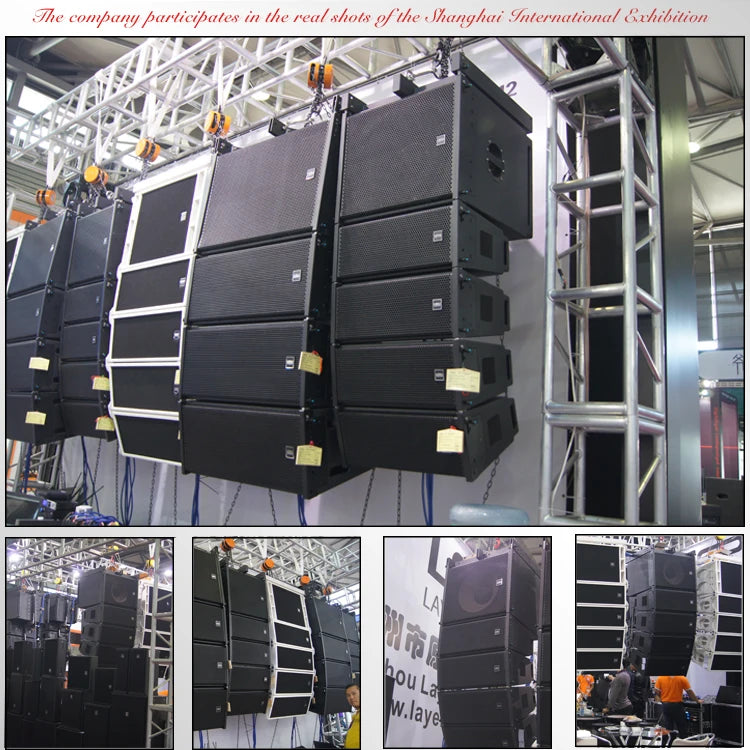 Professional black and white line array stage speakers suspended from a metal truss system in an exhibition setting.
