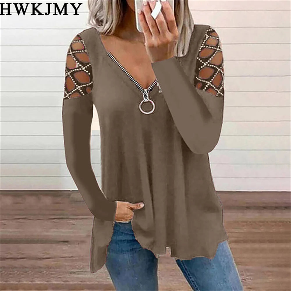 Brown long-sleeve top with a zip-front V-neck and decorative cut-out lattice detailing on the shoulders.
