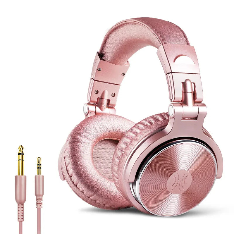 Rose gold wired over-ear studio monitor headphones with cushioned headband and ear cups, plus two audio jack cables.