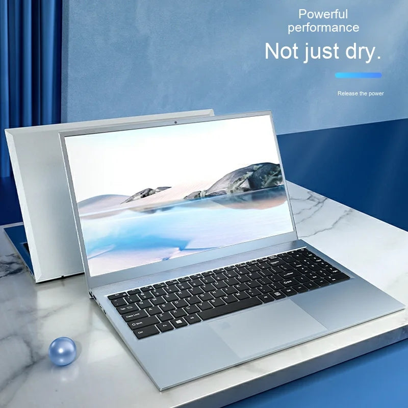 Sleek silver 14-inch laptop with a black keyboard and thin-bezel screen, displayed on a white marble-effect desk.