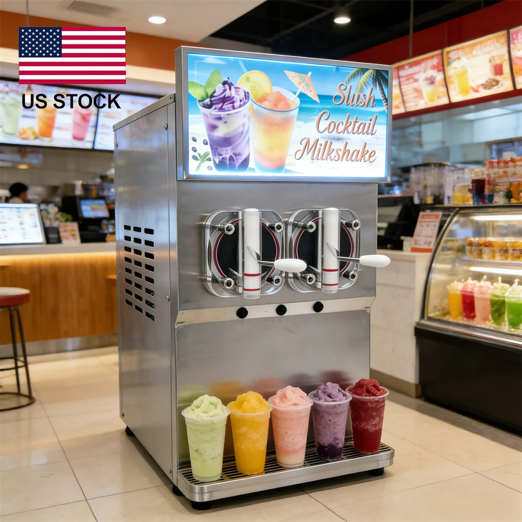 Commercial silver two-tank slushy machine with lighted top display, dispensing handles, and five colorful drinks on tray.