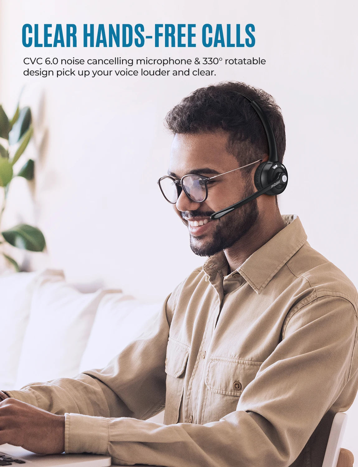 A man wearing a black wireless office headset with a rotatable microphone boom, shown working in a bright room.