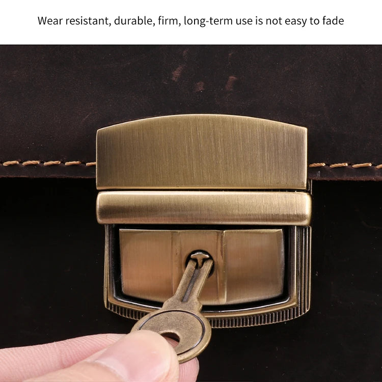 Close-up of a dark brown genuine leather satchel featuring a brushed antique brass metal push-lock clasp and key.
