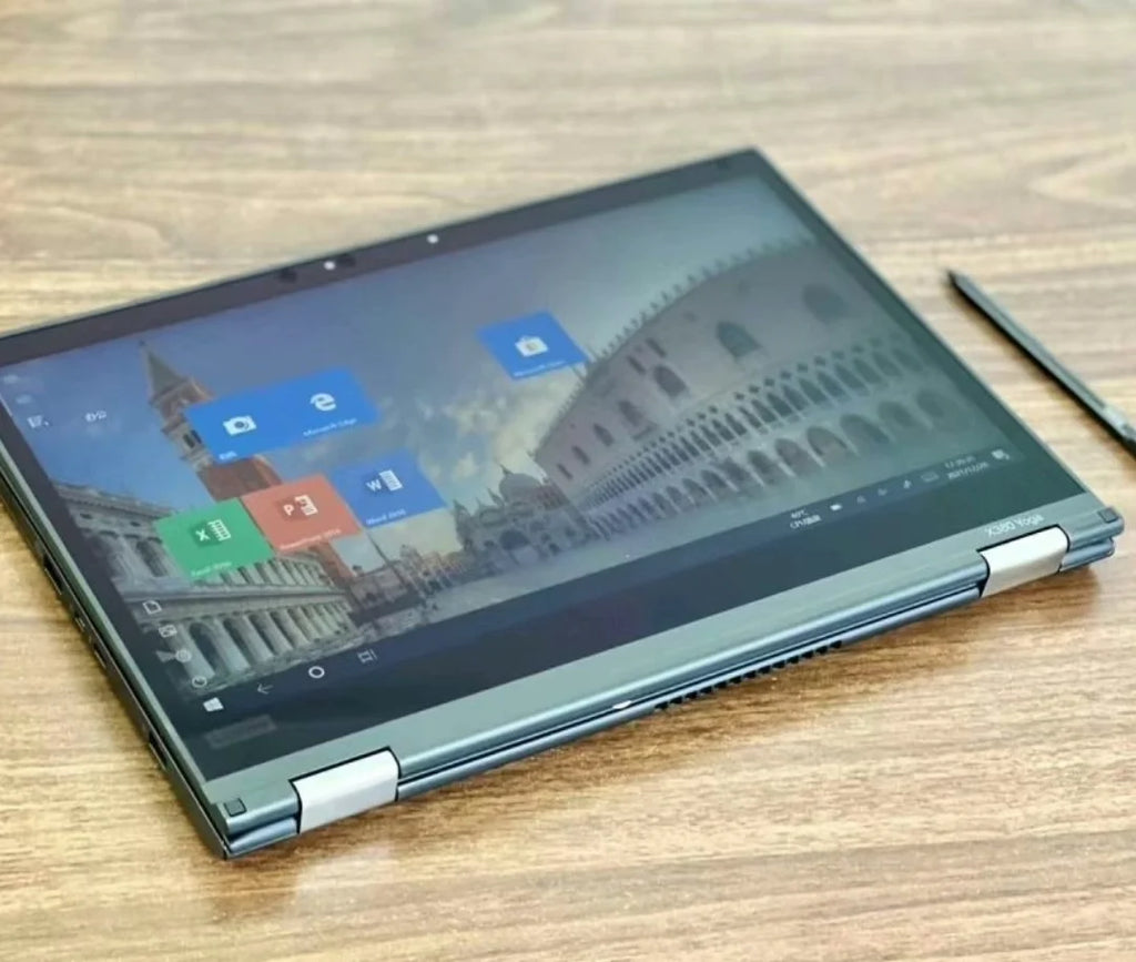 Sleek charcoal grey 13.3-inch 2-in-1 touchscreen business laptop folded flat, including a stylus on a wooden desk.