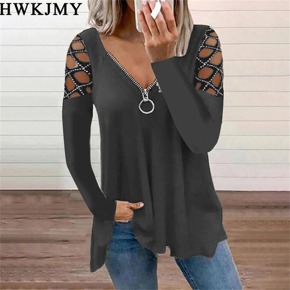 Charcoal long-sleeve top with zip-front V-neck and decorative cut-out lattice shoulders.