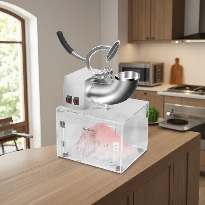 Electric ice shaver machine with a chrome metal top, manual lever, and a clear acrylic storage container.