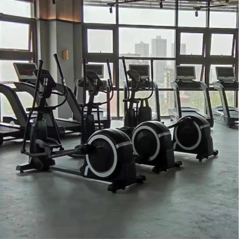 A row of sleek, black commercial elliptical cross trainers with white circular accents, set in a modern indoor gym.