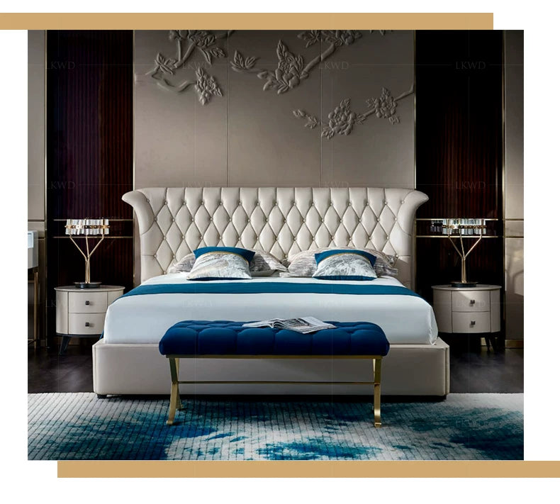 Luxury cream leather double bed with a tall, button-tufted headboard and matching blue velvet bench.