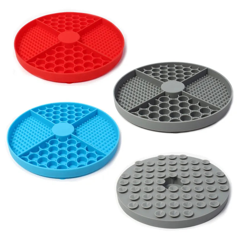 Set of four round, silicone pet slow feeder mats in red, blue, and grey, featuring textured patterns and suction bases.