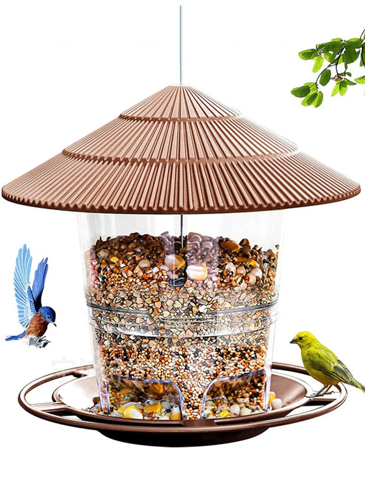 Clear plastic bird feeder with a brown, ribbed, hat-style roof and matching tray base, filled with birdseed.