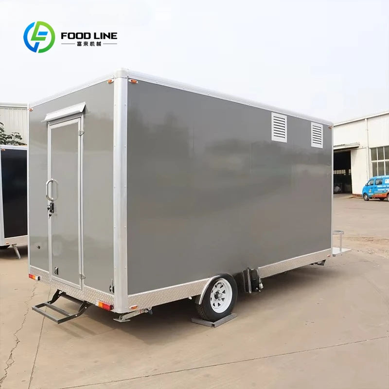 Gray rectangular mobile food trailer with a side door, silver trim, and diamond-plate bottom panels.