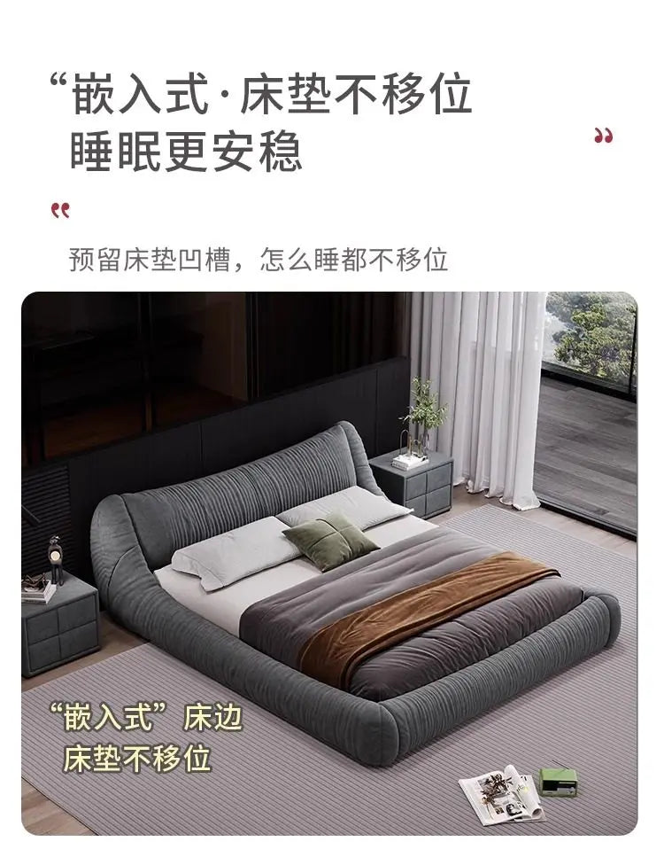 Dark grey upholstered low-profile bed frame with a recessed design to hold the mattress securely in place.