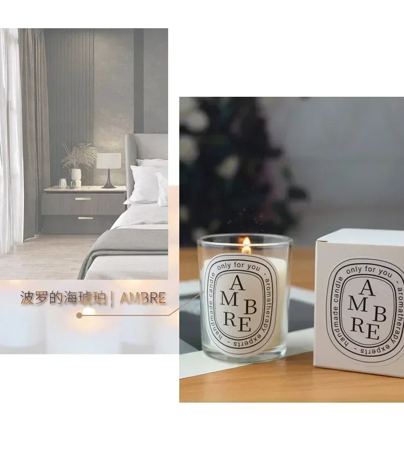 Lit amber-scented aromatherapy candle in a glass jar with minimalist oval label, shown next to its matching white box.