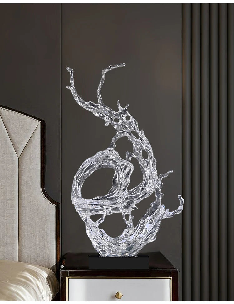 Modern clear resin ornament with an artistic, fluid water-splash design, set on a simple black rectangular base.
