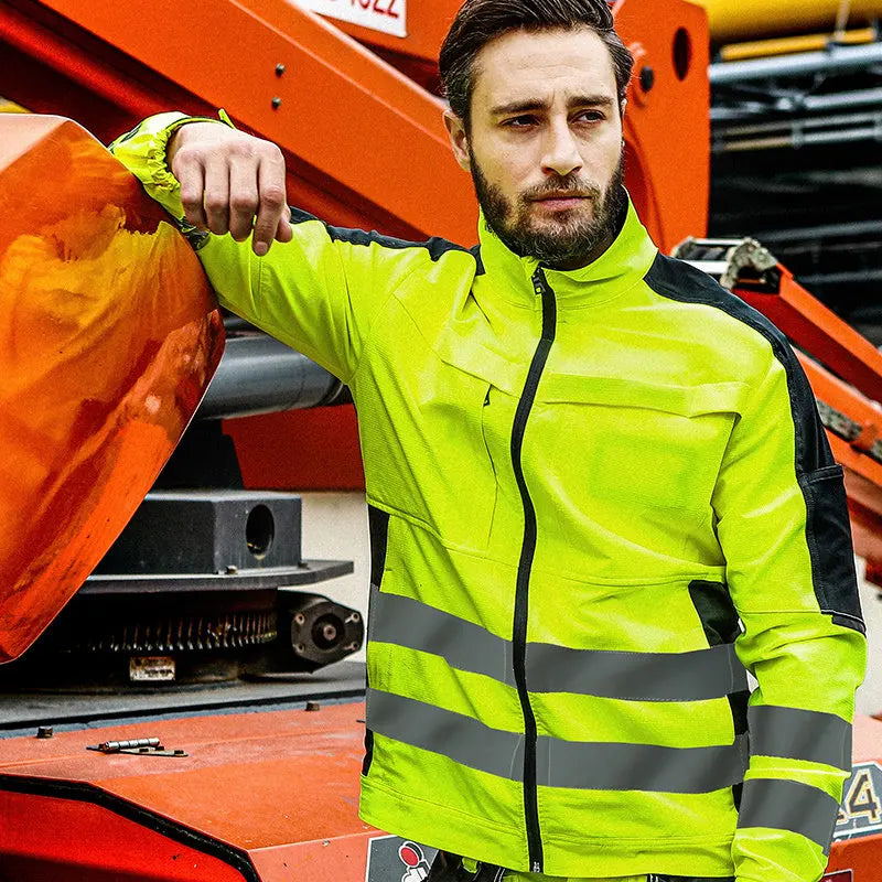 Man wearing a neon yellow high-visibility work jacket with black accents, front zipper, and reflective horizontal strips.