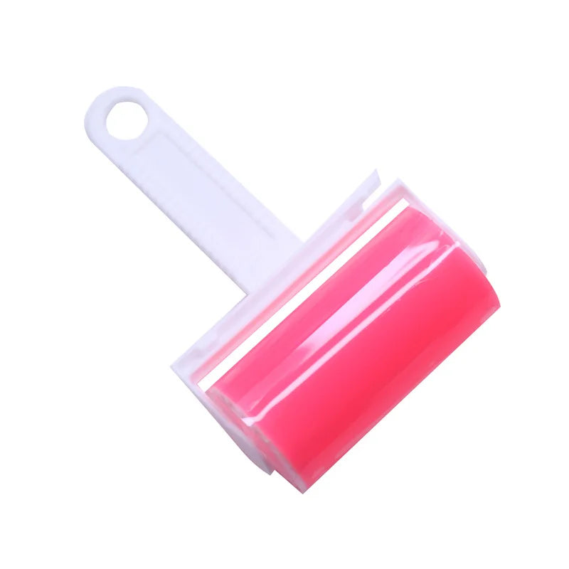 Reusable sticky lint roller with a white plastic handle and a bright pink silicone roller head on a white background.