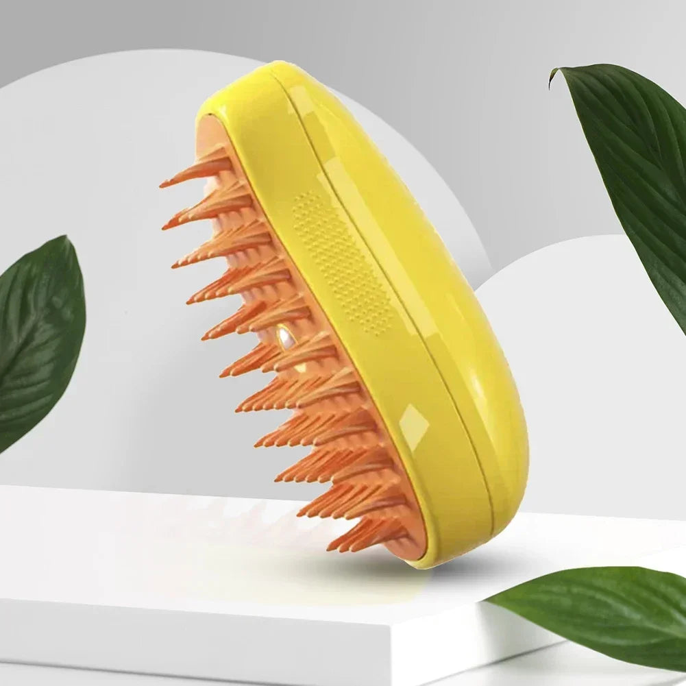 Bright yellow scalp massager brush with flexible orange silicone bristles, set against a modern studio background.