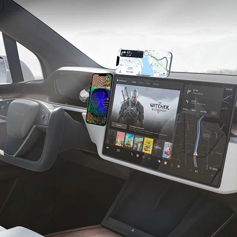 Magnetic black car phone mount attached to a vehicle dashboard, holding two smartphones for navigation and media.