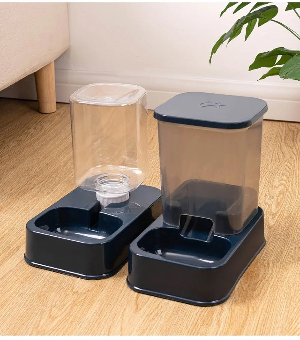 A dark blue pet water dispenser and matching food feeder set with clear plastic containers on a wooden floor.