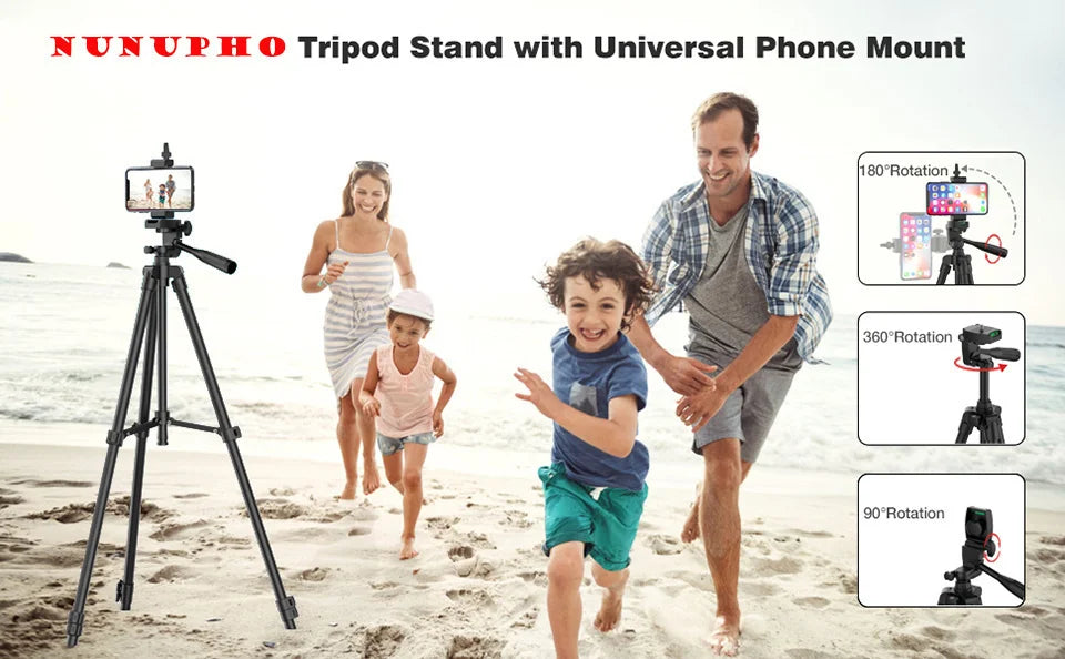 Black tripod stand with a universal phone mount featuring 180, 360, and 90-degree rotation options on a beach.