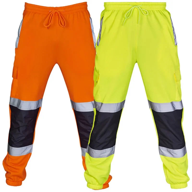 High-visibility work joggers in orange and neon yellow, featuring black knee panels, reflective strips, and a drawstring.