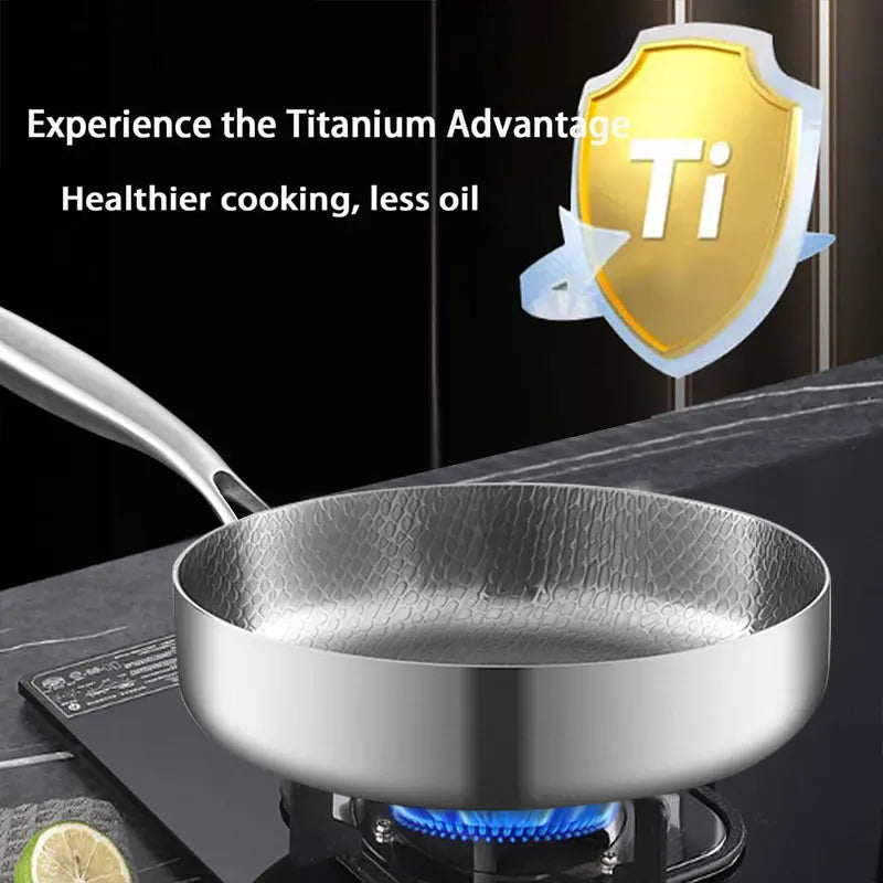 A titanium frying pan on a gas stove, with text reading "Experience the Titanium Advantage. Healthier cooking, less oil".