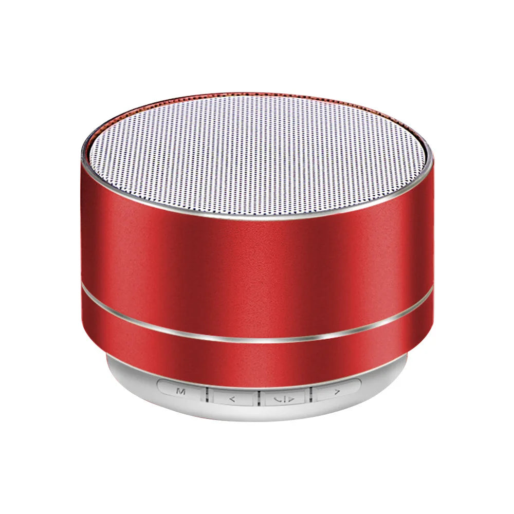 A compact, cylindrical red aluminium Bluetooth speaker with a white mesh top and control buttons on the base.