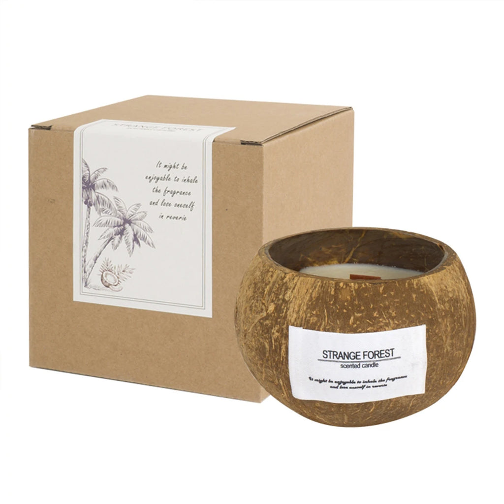 Scented candle in a natural coconut shell container, next to its matching kraft cardboard gift box.