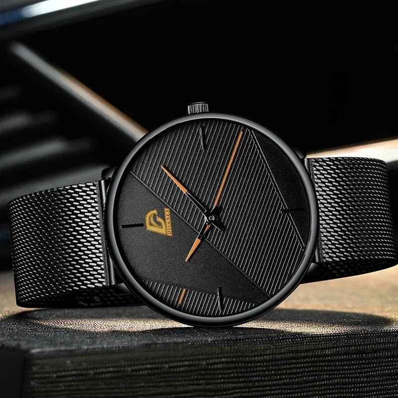 Minimalist men’s ultra-thin quartz watch with a textured black dial, gold accents and a black mesh strap.