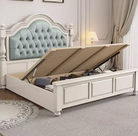 Cream double bed with a button-tufted sage green headboard and a practical gas-lift ottoman storage base.