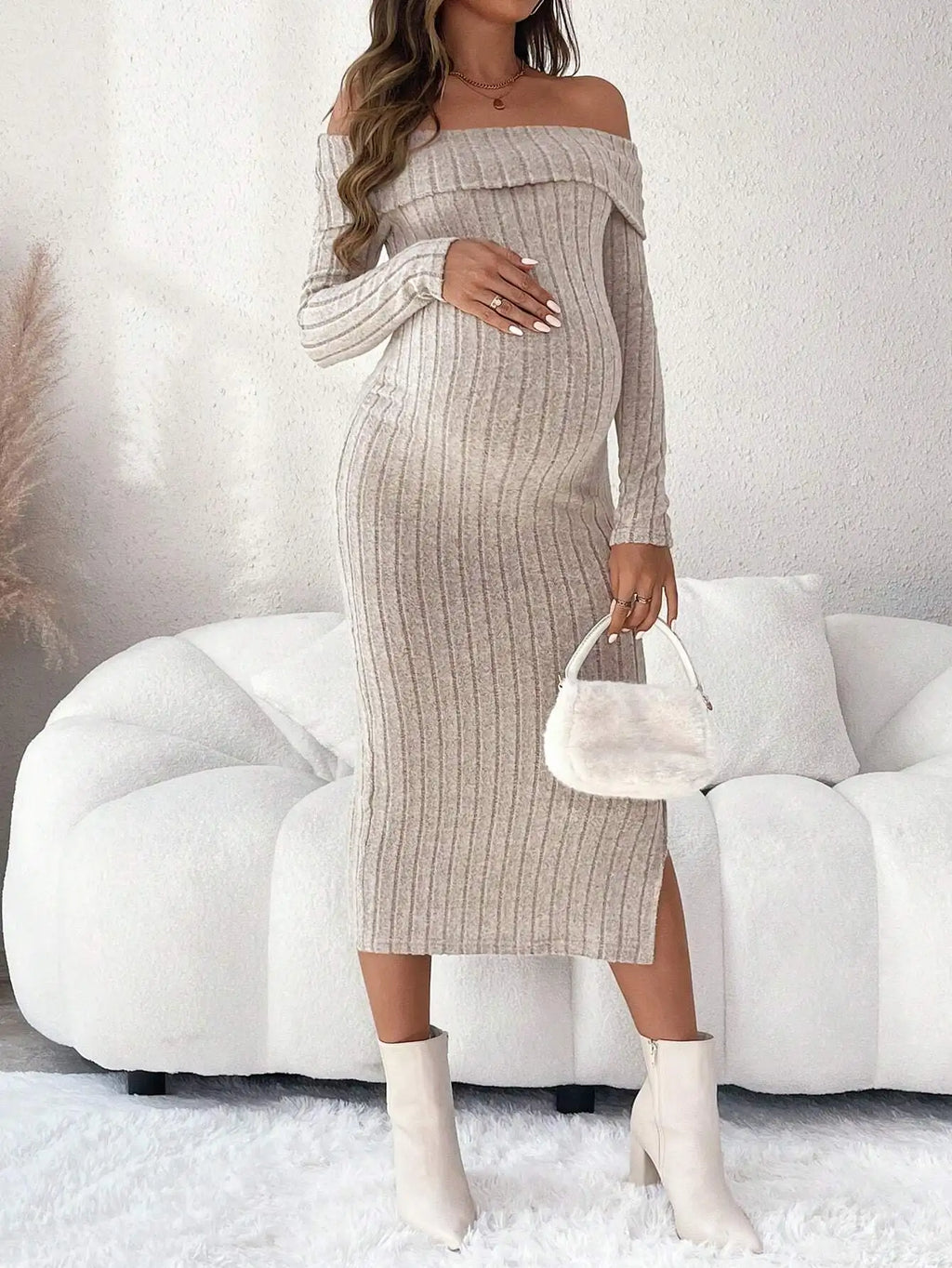 Beige ribbed maternity midi dress with off-the-shoulder neckline, long sleeves, and a side leg slit.