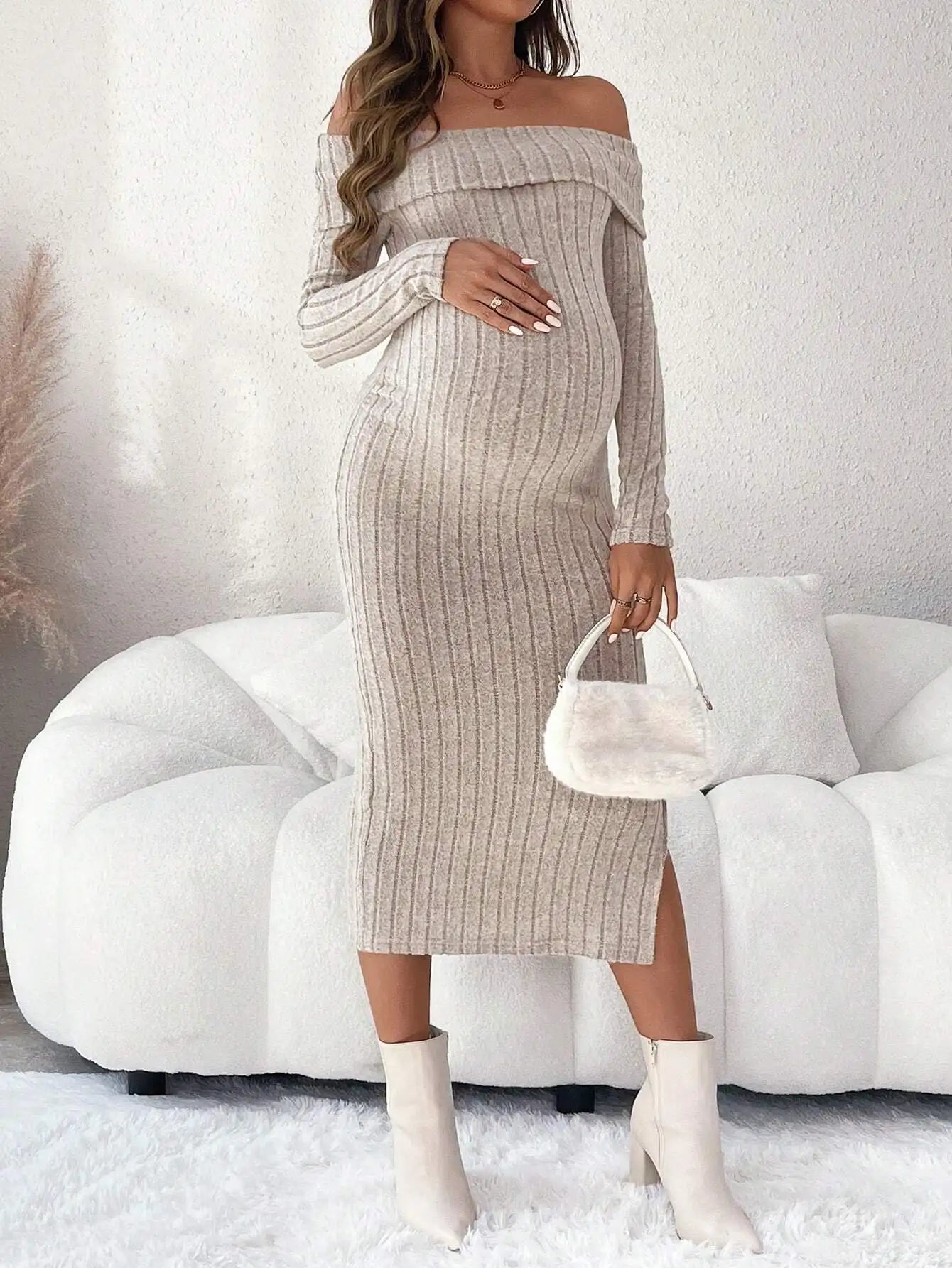 Beige ribbed maternity midi dress with off-the-shoulder neckline, long sleeves, and a side leg slit.