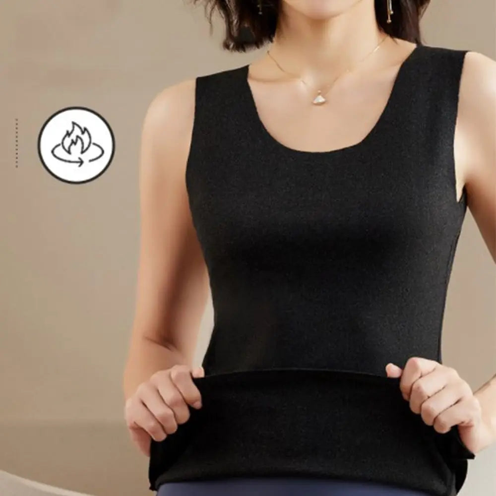 Woman wearing a sleeveless black thermal vest with a scoop neck, shown being stretched to demonstrate elasticity.