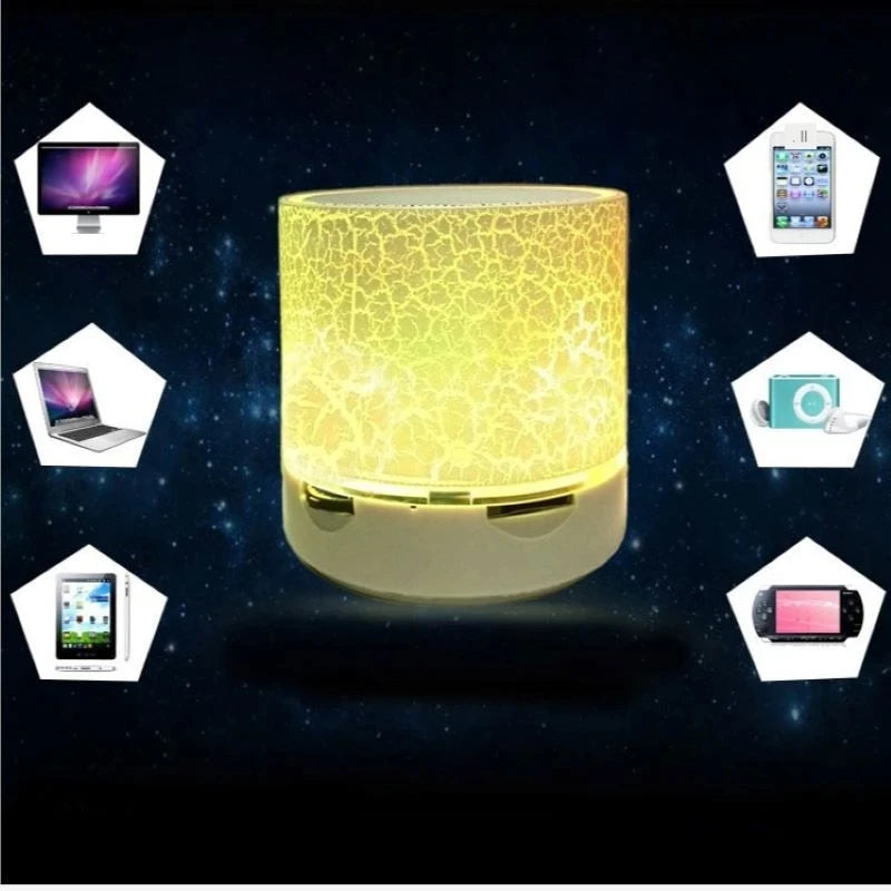 Portable, white wireless LED speaker with a glowing yellow crackle-effect finish, compatible with various devices.