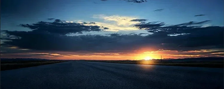 A scenic view of a vast, open road at sunset, symbolising the freedom and reliable power of the 1500W solar inverter.