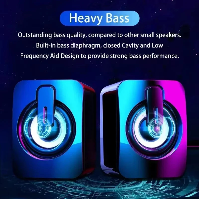 A pair of compact, portable wired speakers featuring iridescent blue and purple shells with glowing circular LED lights.