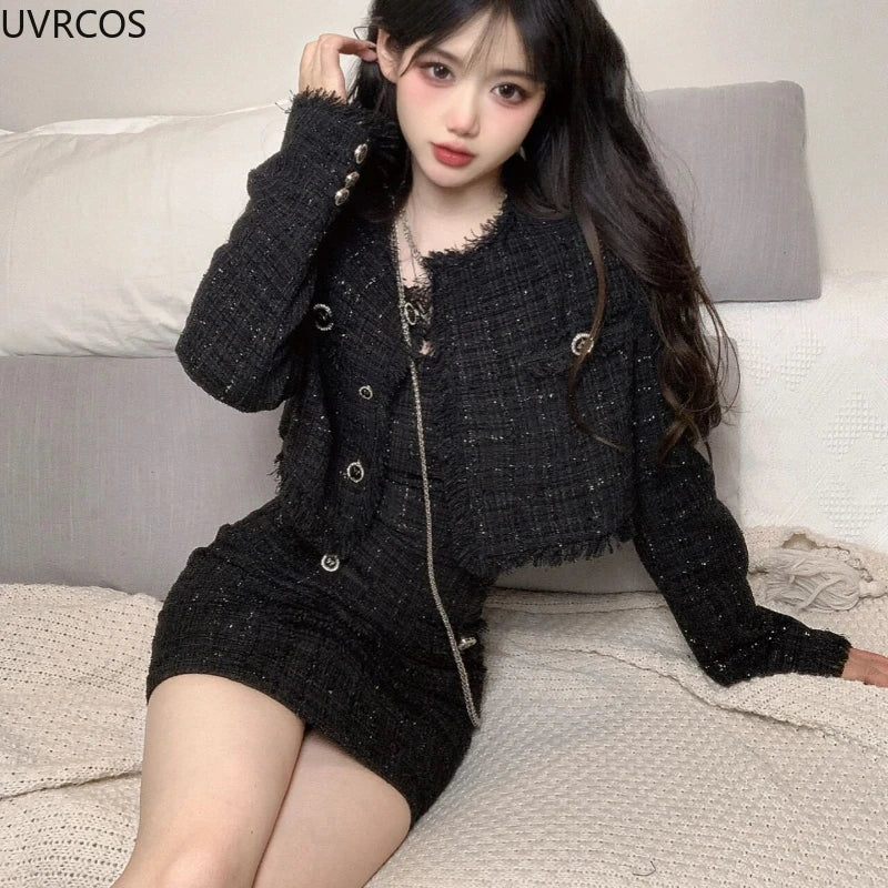 Black two-piece set with a cropped tweed jacket and fitted mini dress featuring frayed tassel trim.