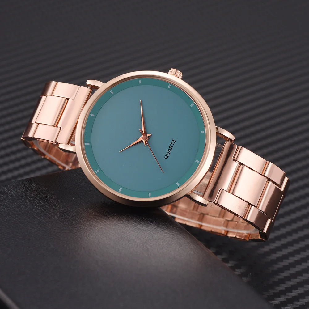 Elegant ladies' rose gold stainless steel watch with a minimalist teal dial and polished bracelet strap.