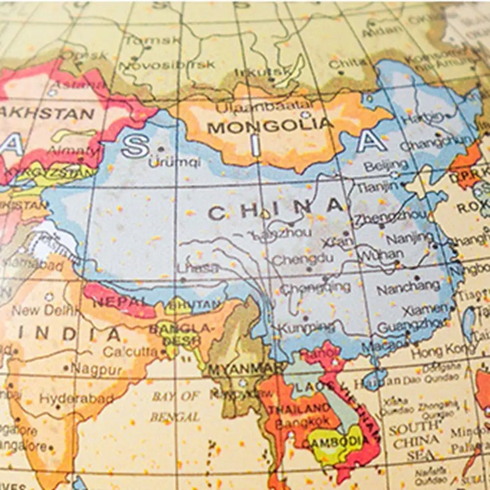 Close-up of a vintage-style world globe showing China and surrounding Asian countries in soft, muted colours.