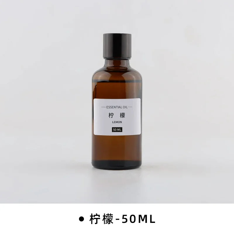 50ml brown glass bottle of lemon essential oil with a black screw cap and simple white label on a white background.